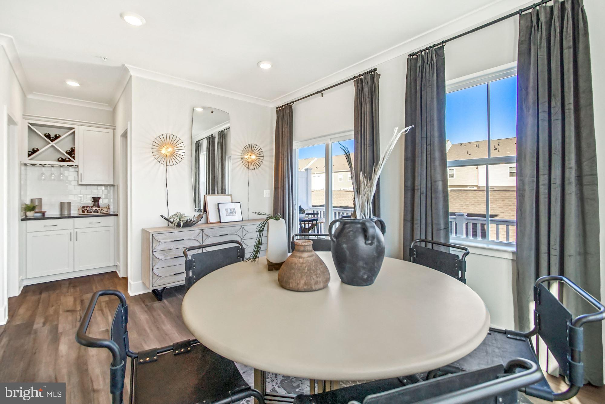 4151 Skipton Place White Plains, MD 20695 - Photo 8 of 27 a dining room with furniture a window and wooden floor
