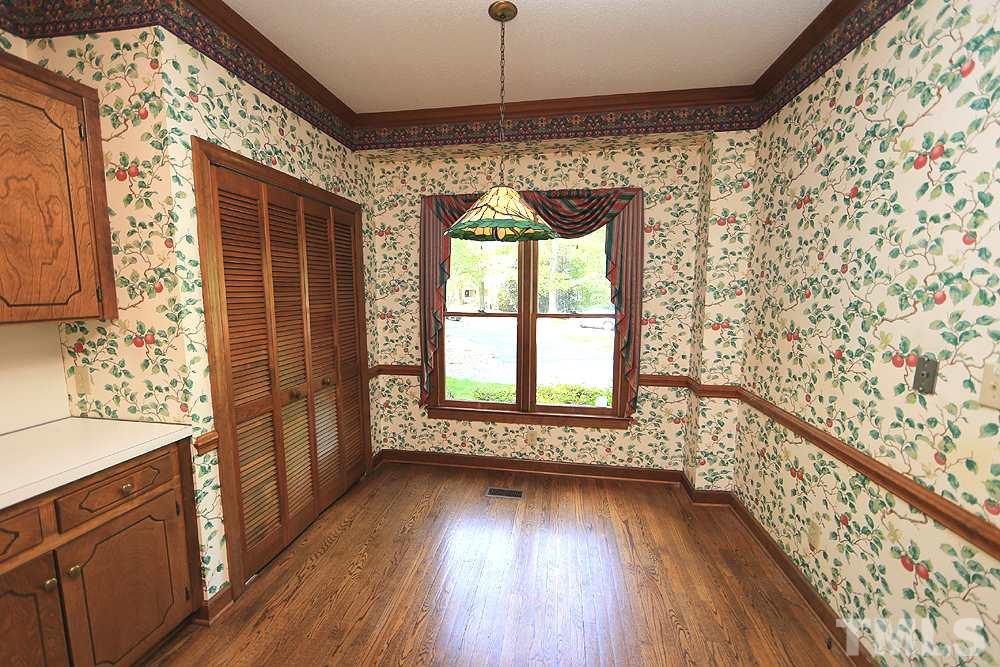 7610 Wilderness Road Raleigh, NC 27613 - Photo 4 of 27 a view of an empty room with wooden floor and a window