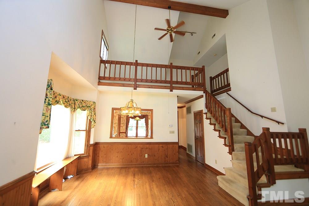 7610 Wilderness Road Raleigh, NC 27613 - Photo 6 of 27 a view of entryway and hall with wooden floor