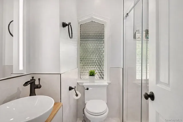 a bathroom with a toilet a sink and shower