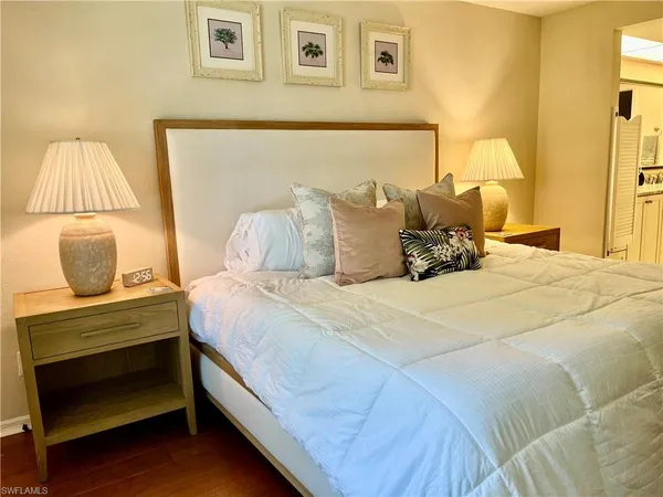 a bedroom with a bed and lamp