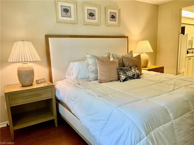 a bedroom with a bed and lamp