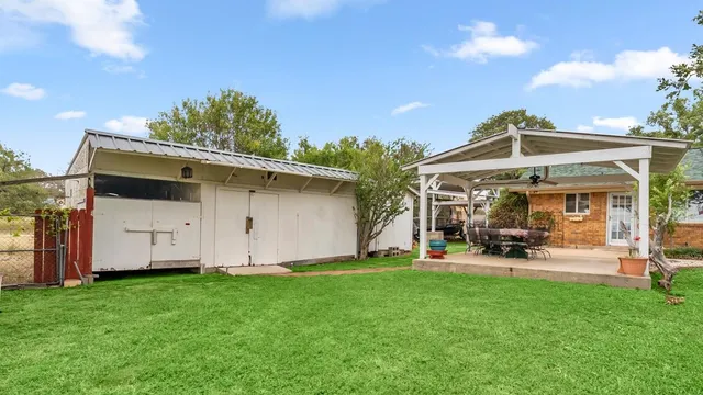 a view of a room with a ceiling fan and a window