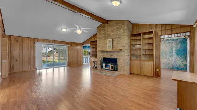 a kitchen with granite countertop a sink and wooden floor