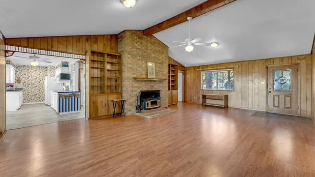 a empty room with wooden floor and chandelier