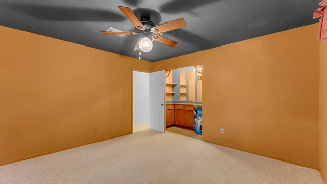 a spacious bathroom with a shower curtain and a chandelier