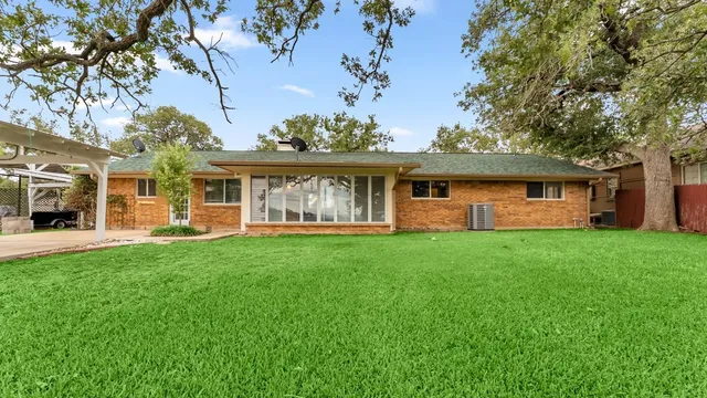 a view of a house with backyard sitting area and garden