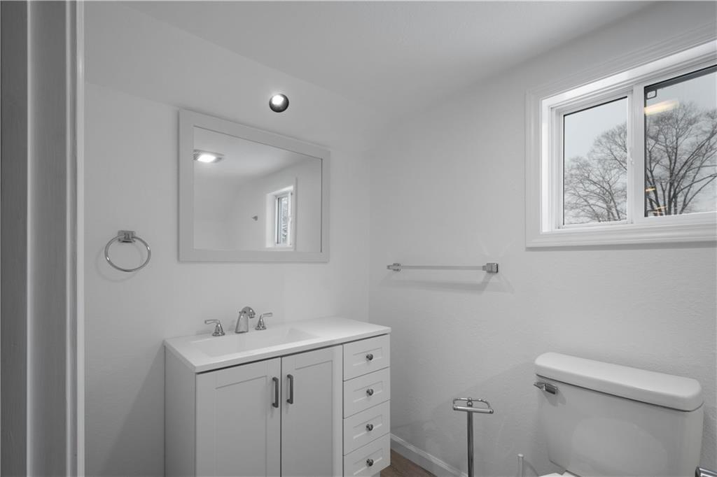 30 Evans Road Charleroi, PA 15022 - Photo 22 of 32 a bathroom with a toilet a sink a mirror and a window