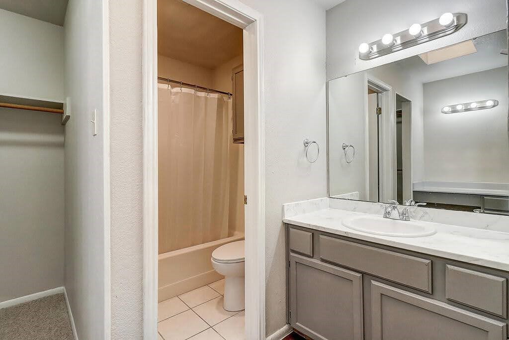 929 St Timothy Street Corpus Christi, TX 78418 - Photo 15 of 35 a bathroom with a sink a toilet and a mirror