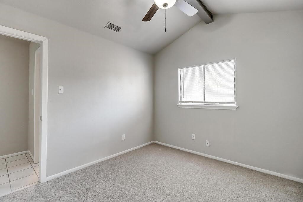 929 St Timothy Street Corpus Christi, TX 78418 - Photo 19 of 35 an empty room with a chandelier fan and windows