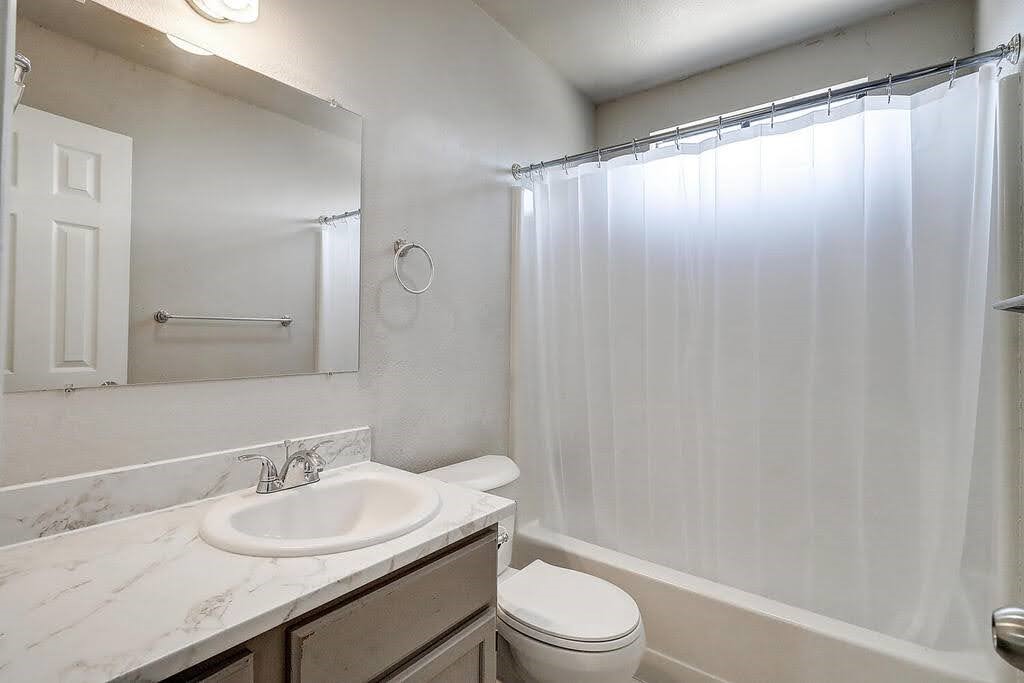 929 St Timothy Street Corpus Christi, TX 78418 - Photo 20 of 35 a bathroom with a granite countertop sink toilet and shower