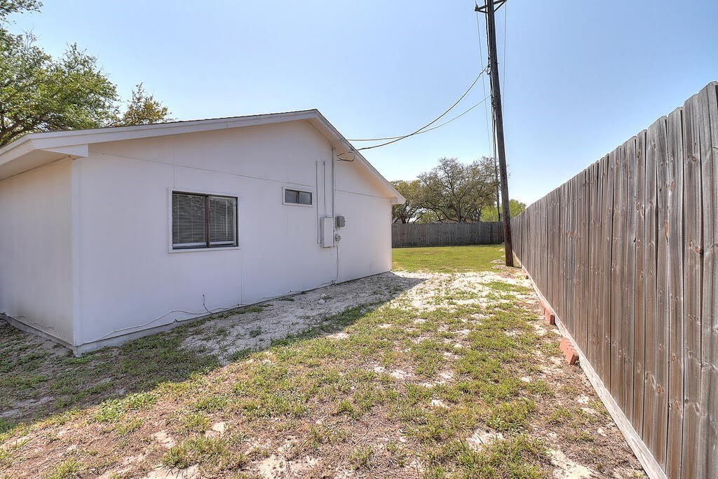 929 St Timothy Street Corpus Christi, TX 78418 - Photo 29 of 35 a backyard of a house with a wooden fence