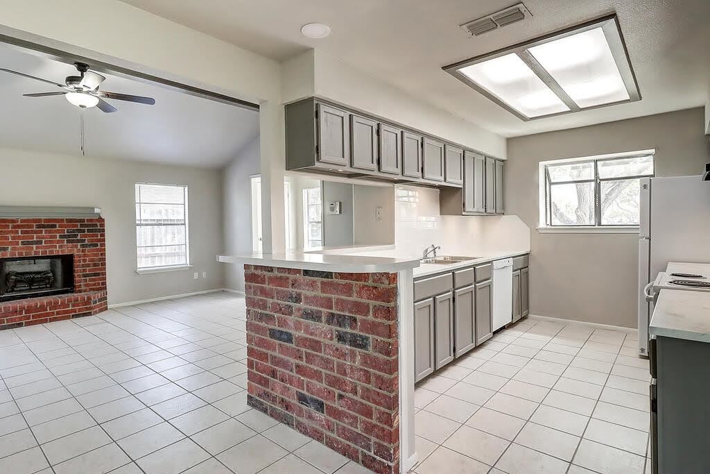 929 St Timothy Street Corpus Christi, TX 78418 - Photo 8 of 35 a kitchen that has a sink and a stove in it