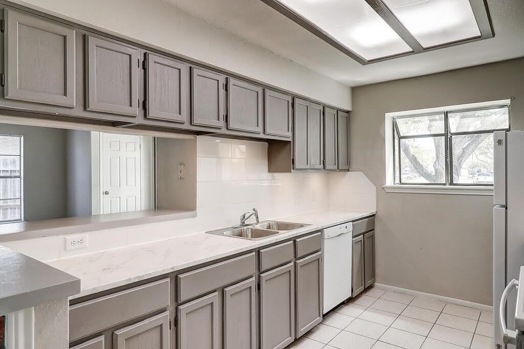 929 St Timothy Street Corpus Christi, TX 78418 - Photo 10 of 35 a kitchen with stainless steel appliances granite countertop a sink window and cabinets