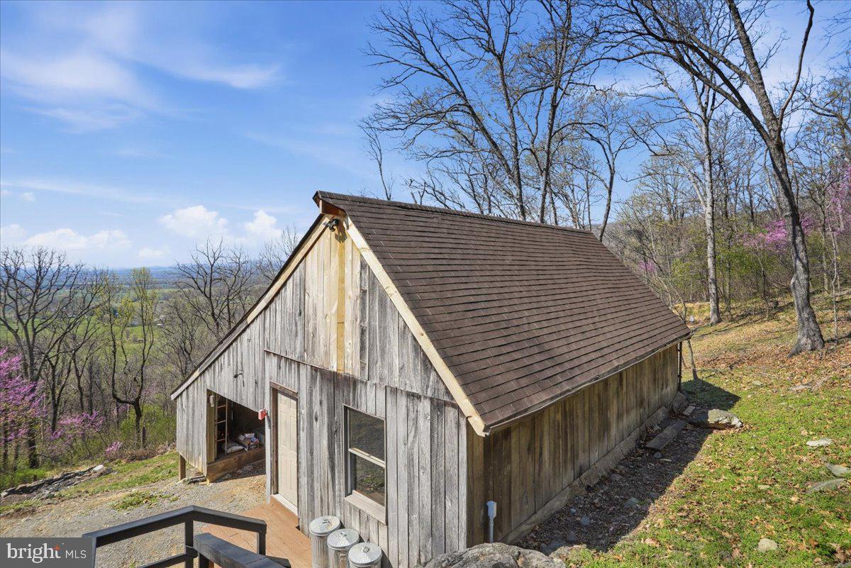 19897 Foresthill Road Bluemont, VA 20135 - Photo 26 of 39 a backyard of a house with large trees and table and chairs