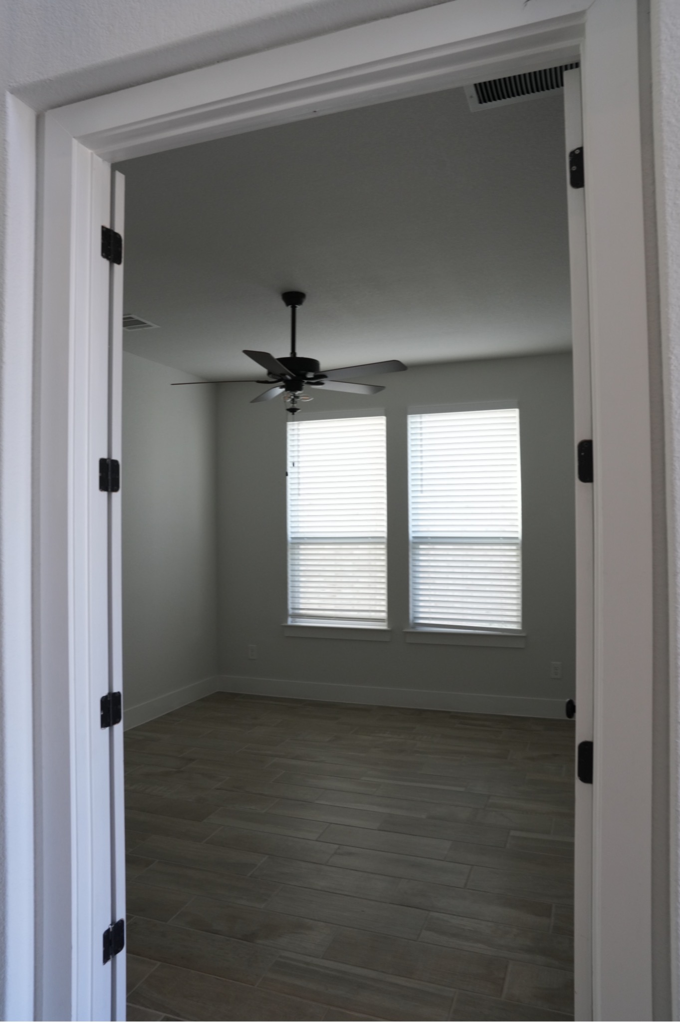 3812 Mercer Road Georgetown, TX 78628 - Photo 18 of 33 Empty room with dark wood-style flooring and a ceiling fan