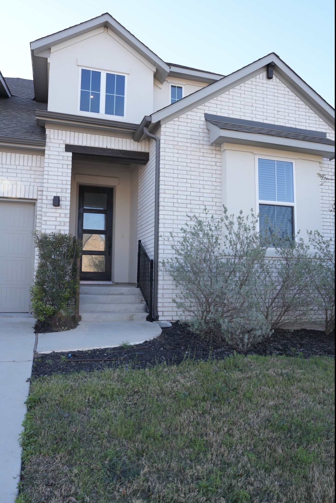 3812 Mercer Road Georgetown, TX 78628 - Photo 2 of 33 Doorway to property with brick siding, a yard, and a garage