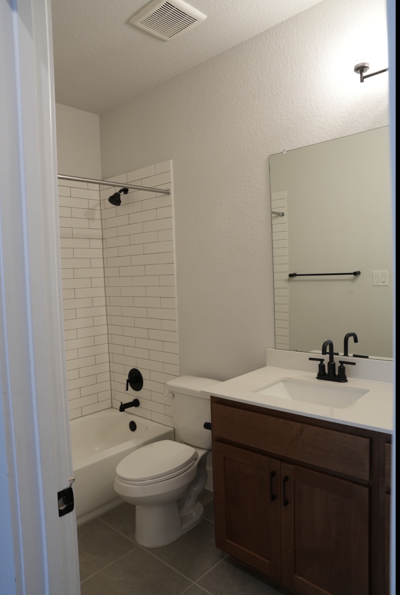 3812 Mercer Road Georgetown, TX 78628 - Photo 23 of 33 Full bathroom featuring vanity, dark tile patterned floors, and bathtub / shower combination