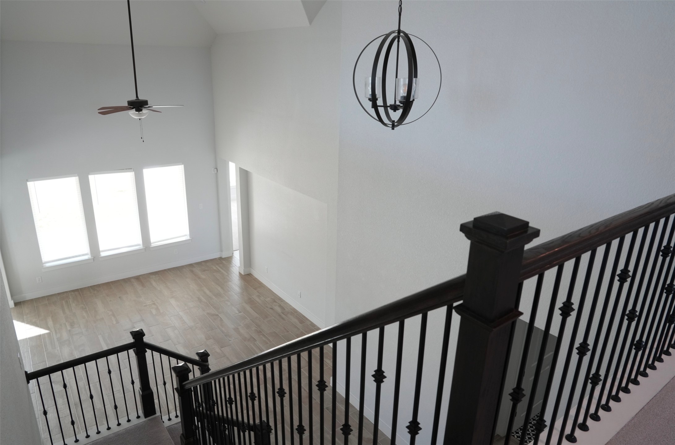 3812 Mercer Road Georgetown, TX 78628 - Photo 25 of 33 Stairs with a high ceiling, ceiling fan, wood finished floors, and suspended lighting