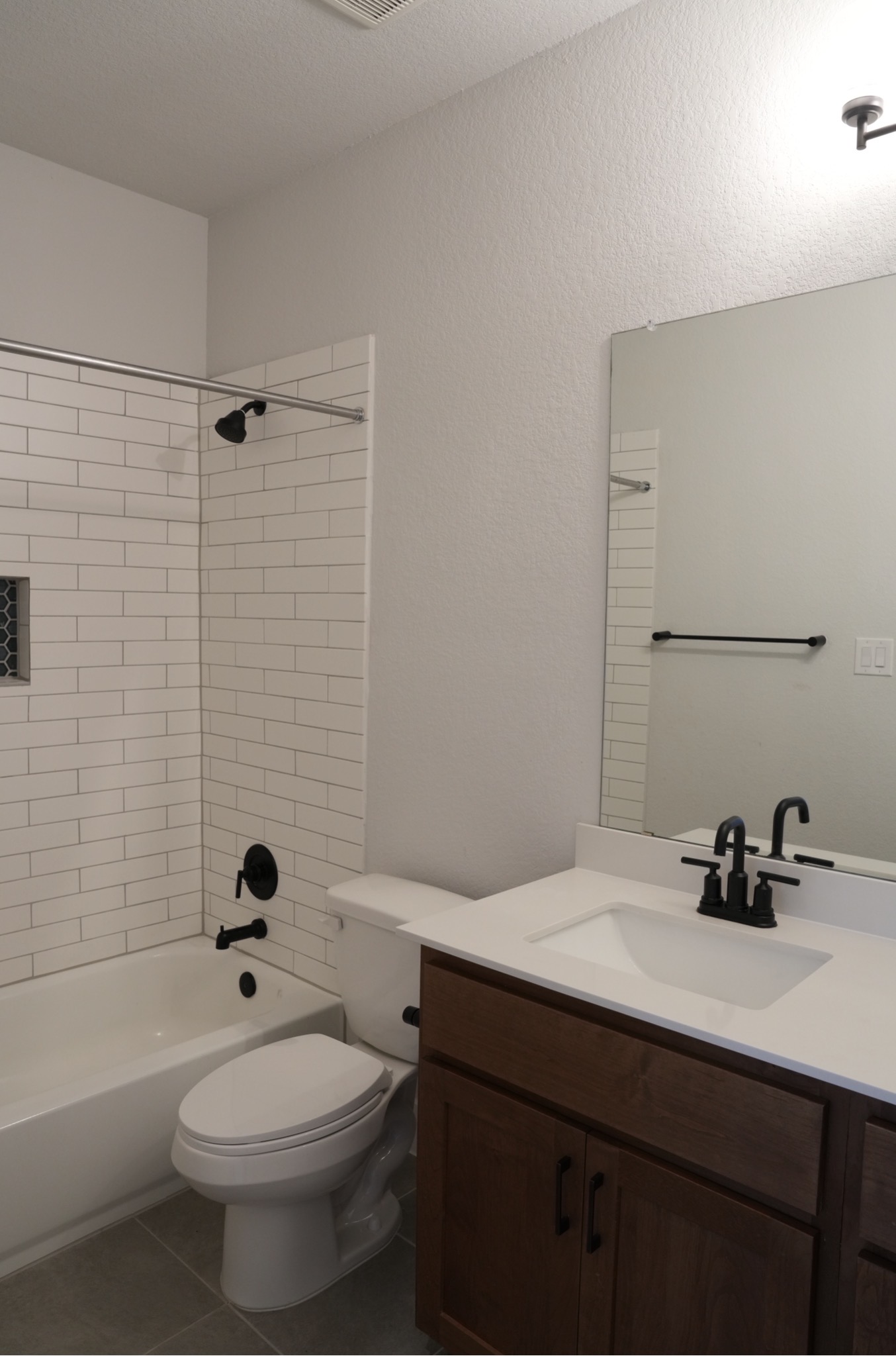 3812 Mercer Road Georgetown, TX 78628 - Photo 28 of 33 Bathroom with vanity, shower combination, and dark tile patterned floors