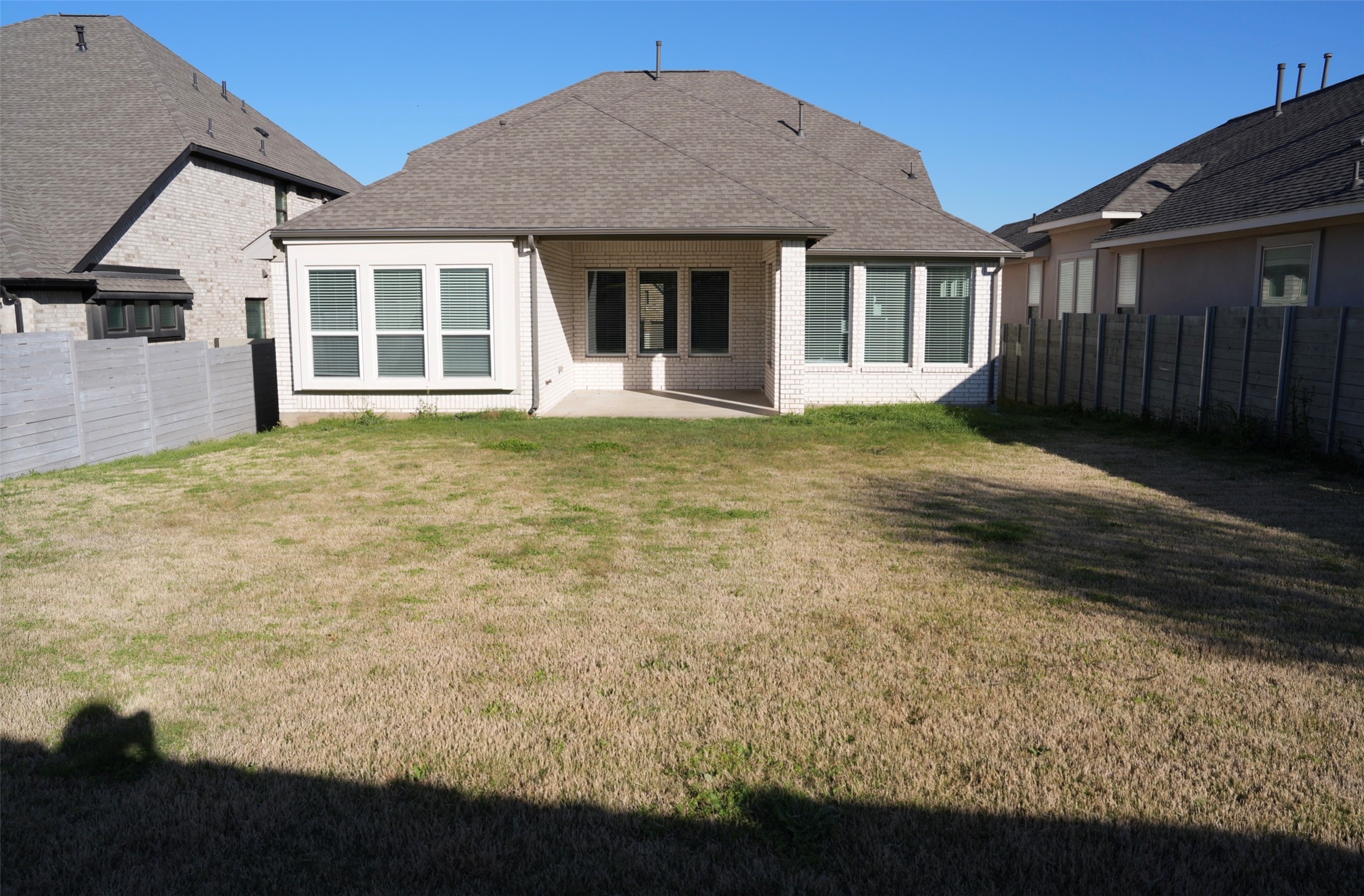 3812 Mercer Road Georgetown, TX 78628 - Photo 32 of 33 Back of property featuring a patio, a fenced backyard, brick siding, and a shingled roof