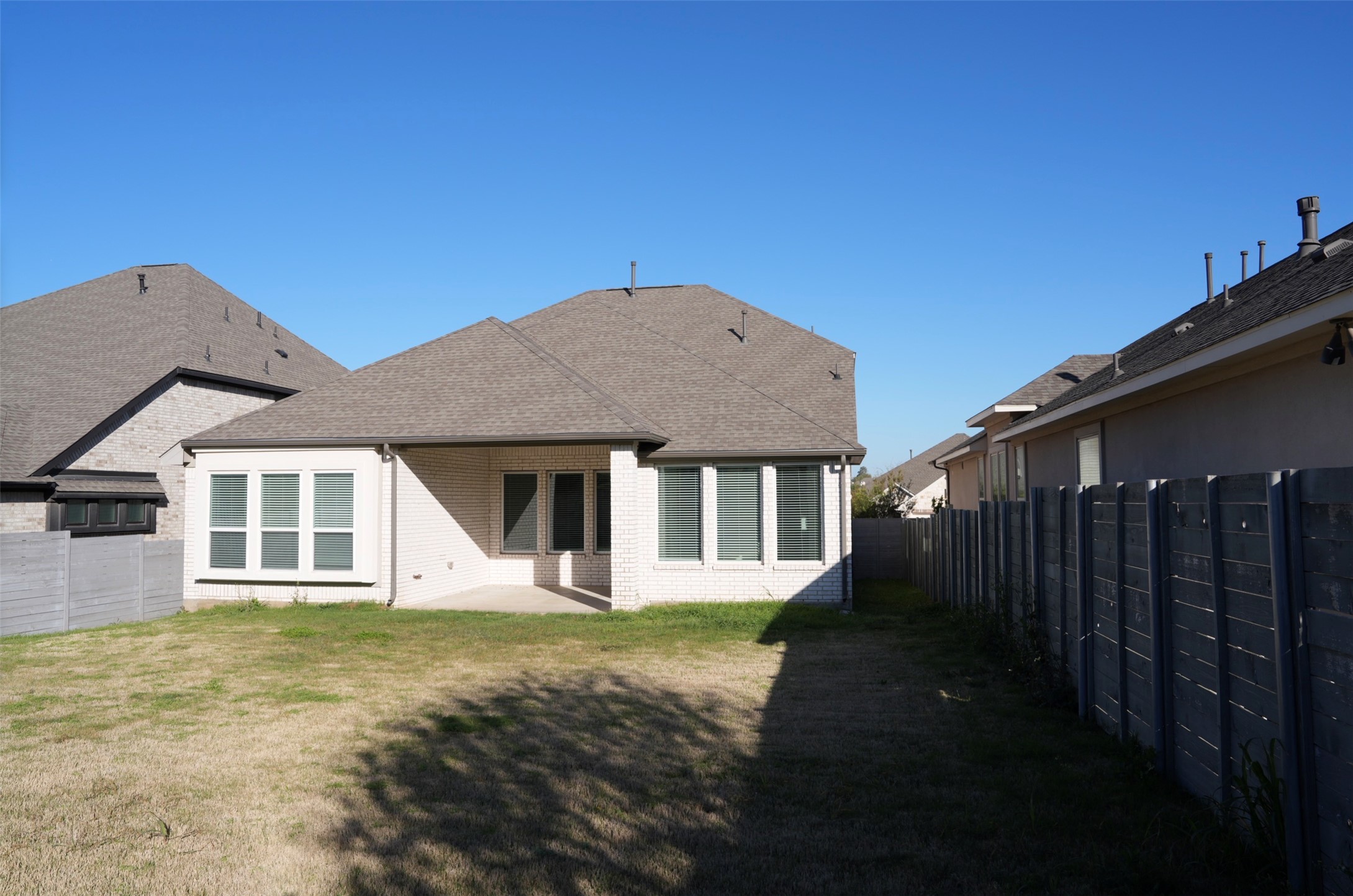 3812 Mercer Road Georgetown, TX 78628 - Photo 33 of 33 Rear view of property with a patio area, brick siding, a fenced backyard, and roof with shingles