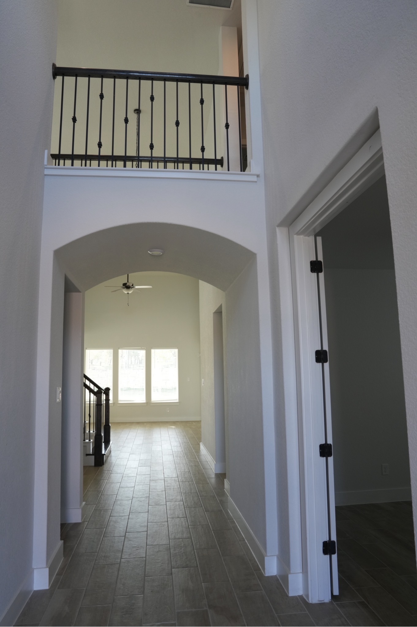 3812 Mercer Road Georgetown, TX 78628 - Photo 4 of 33 Hall with a high ceiling, arched walkways, and dark wood-type flooring