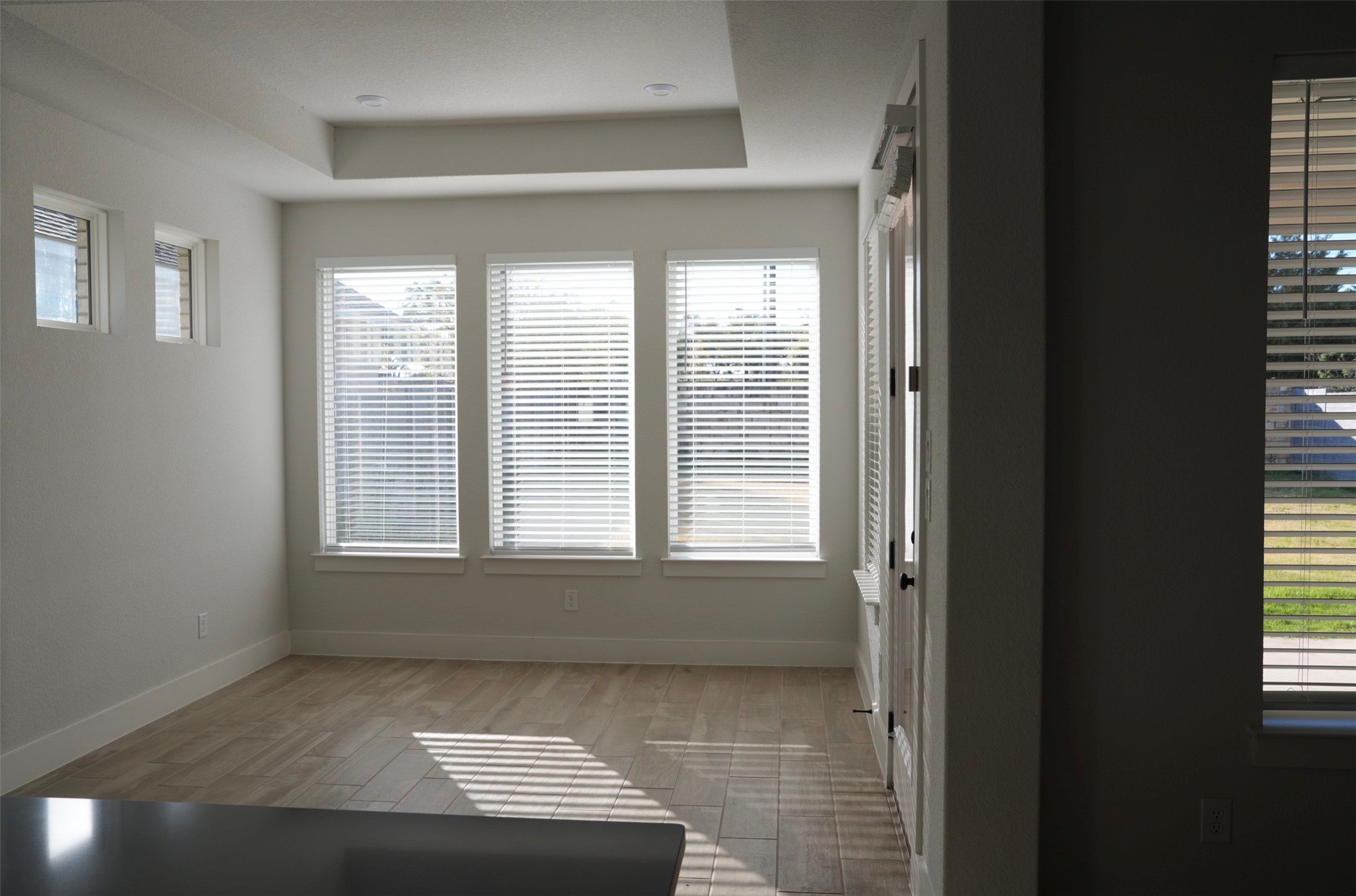 3812 Mercer Road Georgetown, TX 78628 - Photo 9 of 33 Nook with plenty of natural light, a tray ceiling, and light wood-style flooring