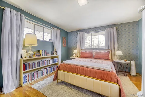 a bedroom with a bed and a book shelf