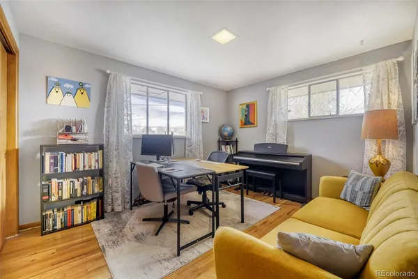 a livingroom with workspace and a couch