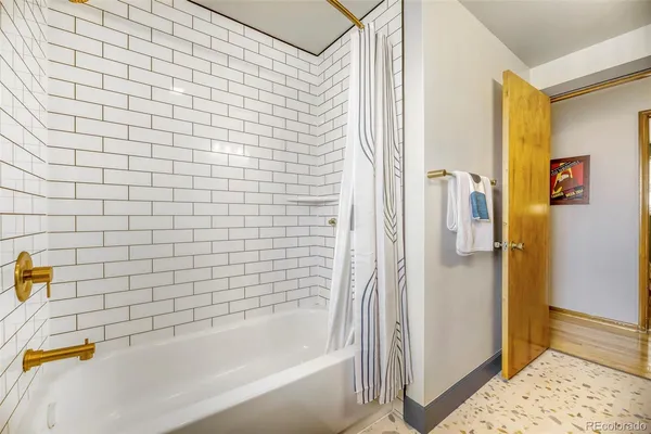 a bathroom with a bathtub and a shower