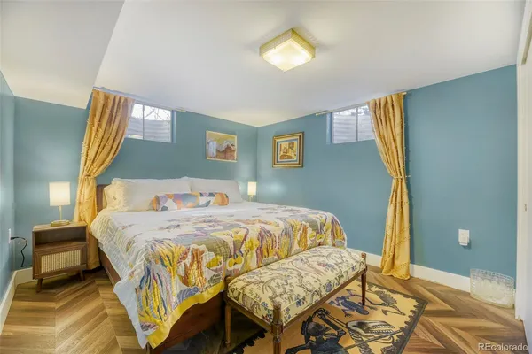 a bedroom with a bed and a chandelier