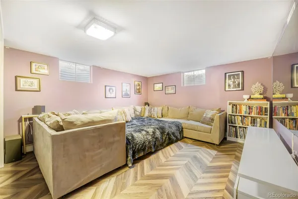 a living room with furniture and paintings on the wall