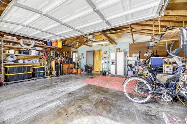 a view of a patio with a table and chairs and couches under an umbrella with a fire pit