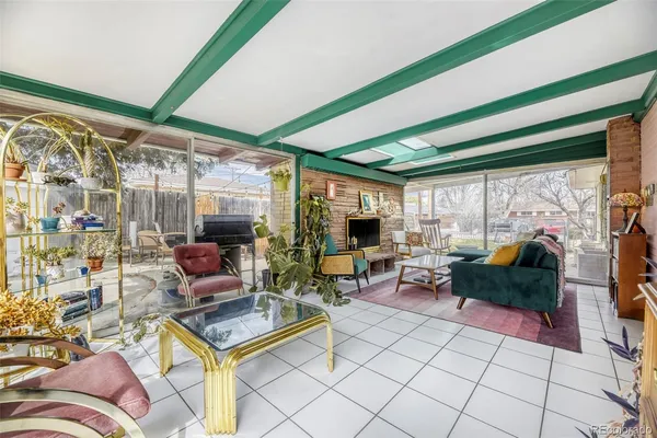 a living room with lots of furniture and a floor to ceiling window