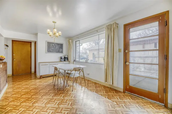 a view of a dining room with furniture and chandelier