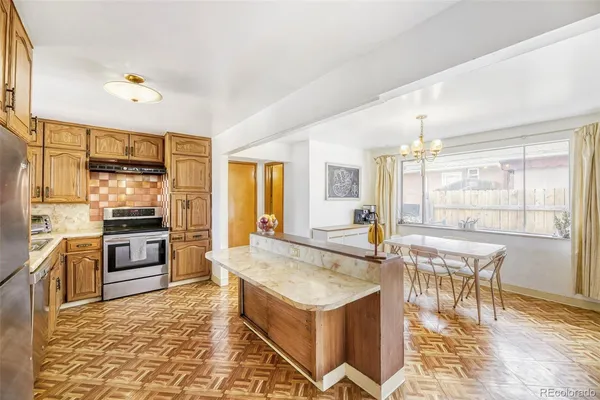 a kitchen with a stove a sink and a refrigerator