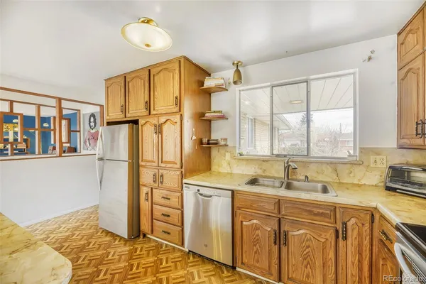 a kitchen with stainless steel appliances granite countertop a stove a sink and a refrigerator