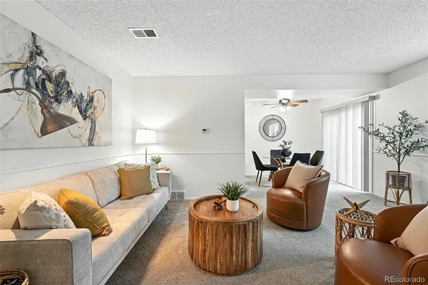a living room with furniture and a chandelier
