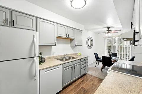 a kitchen with stainless steel appliances granite countertop a sink a stove and a refrigerator