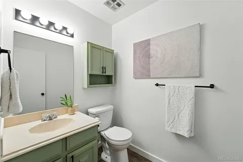 a bathroom with a sink toilet and mirror
