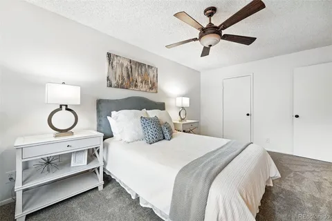 a bedroom with a bed and ceiling fan