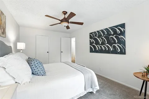 a bedroom with a large bed and a chandelier