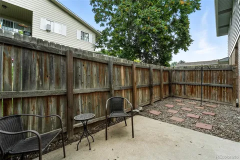 a view of a chairs and table in the balcony