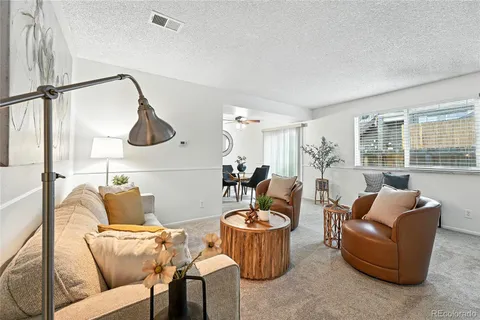 a living room with furniture and a floor to ceiling window
