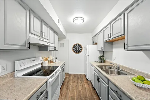 a kitchen with stainless steel appliances a stove a sink and cabinets