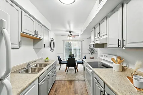 a kitchen with stainless steel appliances granite countertop a sink stove and cabinets