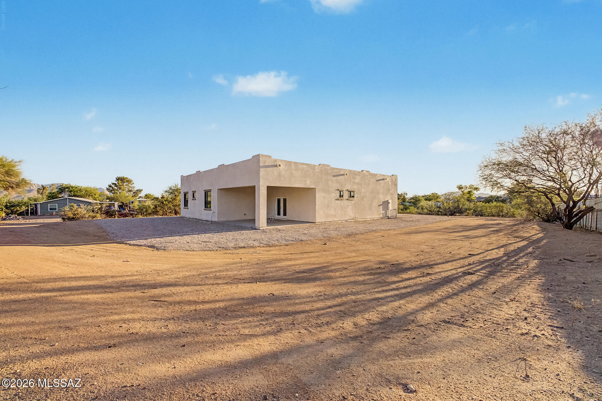 4601 East Magoo Road Tucson, AZ 85739 - Photo 22 of 38 a front view of a house with a yard and garage