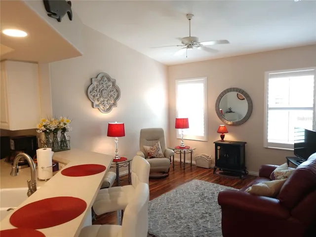 a living room with furniture a window and a chandelier