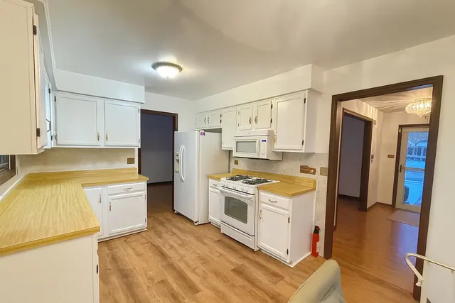 a kitchen with a stove a sink and a refrigerator